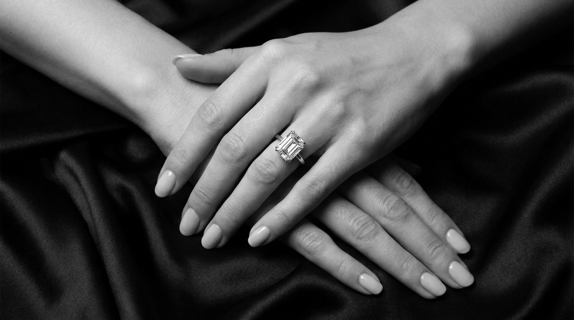 Hands wearing a diamond solitaire